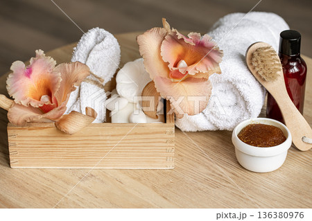 Spa composition with body care products in a wooden box and Thai orchid flowers. Spa composition with body care products in a wooden box and Thai orchid flowers. 136380976