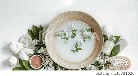 Spa composition with water for beauty treatments and fresh flowers. 136381026