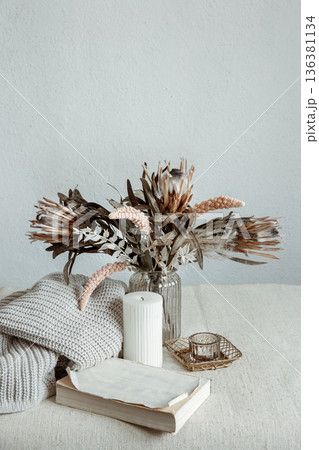 Cozy composition with a bouquet of dried flowers and home decor details. Cozy composition with a bouquet of dried flowers and home decor details. 136381134