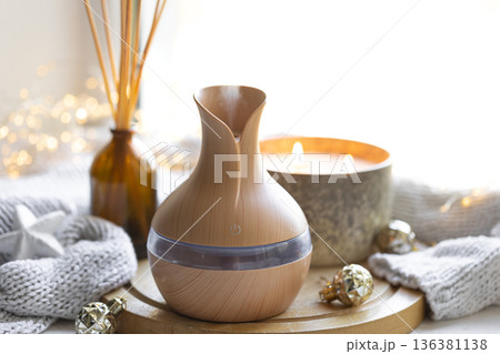 Still life with an aroma diffuser for moisturizing the air and winter decor. Still life with an aroma diffuser for moisturizing the air and winter decor. 136381138