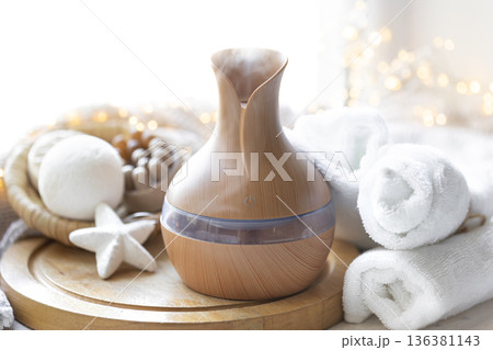 Still life with an aroma diffuser for moisturizing the air and winter decor. Still life with an aroma diffuser for moisturizing the air and winter decor. 136381143