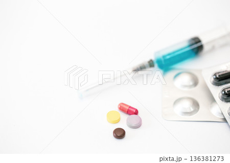 Syringe and pills on a white background isolated, close-up. 136381273
