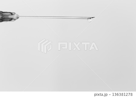 Syringe with drop isolated on white background 136381278