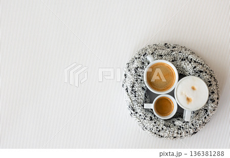 Three cups of coffee on a white texture background, flat lay. 136381288