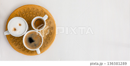 Three cups of coffee on a white texture background, flat lay. 136381289