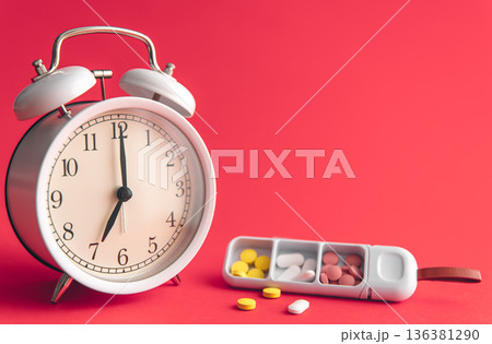 Time for health check concept. White alarm clock with pills. 136381290