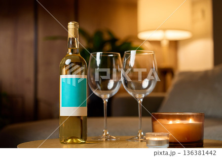 Bottle of white wine with two glasses and candles at home 136381442