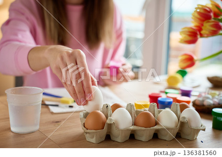 Woman preparing eggs for Easter decorating at home 136381560