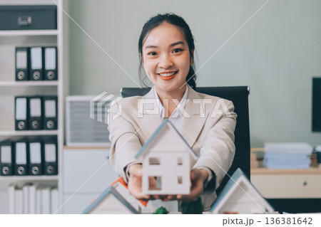 real estate agent home miniature model on documents sale and purchase of apartment notarial deed real estate agent home miniature model on documents sale and purchase of apartment notarial deed 136381642