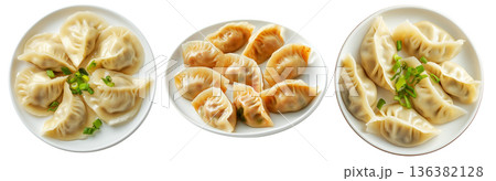 Steamed mandu dumplings placed in circular pattern on ceramic plate, isolated on white transparent background Steamed mandu dumplings placed in circular pattern on ceramic plate, isolated on white transparent background 136382128