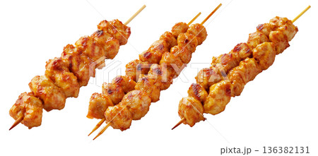 Grilled chicken Satay skewer with a golden brown glaze, isolated on white background, concept of tasty street food Grilled chicken Satay skewer with a golden brown glaze, isolated on white background, concept of tasty street food 136382131
