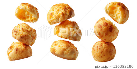 Stack of Brazilian cheesy bread balls with golden crust and holes, isolated on white background, concept of Pao de Queijo food 136382190
