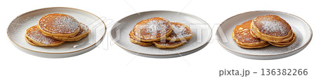 Stack of fluffy golden pancakes sprinkled with powdered sugar on a ceramic plate, isolated on white background Stack of fluffy golden pancakes sprinkled with powdered sugar on a ceramic plate, isolated on white background 136382266