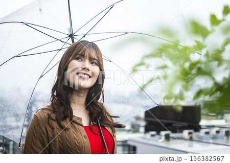 雨の中傘をさす若い女性 雨の中傘をさす若い女性 136382567
