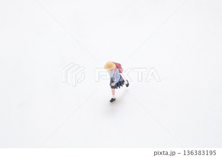 Miniature student runs forward across clean white studio background 136383195