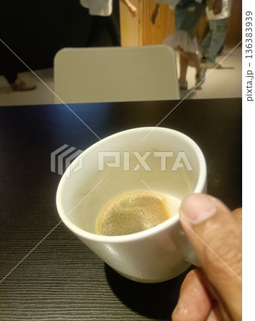 Casual coffee break hand holding white cup espresso cafe table closeup man Casual coffee break hand holding white cup espresso cafe table closeup man 136383939