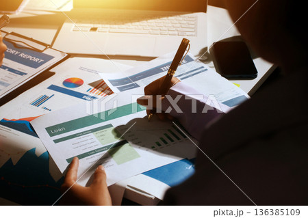 Above table with finance papers, graphs and big data during teamwork meeting with accounting or marketing team discussing budget, strategy or growth development. Closeup of SEO team doing research Above table with finance papers, graphs and big data during teamwork meeting with accounting or marketing team discussing budget, strategy or growth development. Closeup of SEO team doing research 136385109