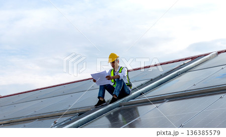 Engineer service check installation solar cell on the roof of factory.  136385579