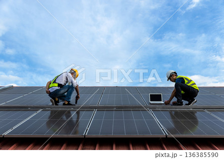 Engineer service check installation solar cell on the roof of factory. Engineer service check installation solar cell on the roof of factory. 136385590