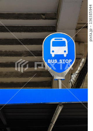 Bus stop sign n a rooftop in the old town area. indicating public transportation point in urban environment at daytime. 136385944