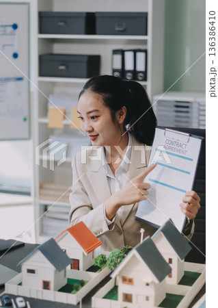real estate agent home miniature model on documents sale and purchase of apartment notarial deed real estate agent home miniature model on documents sale and purchase of apartment notarial deed 136386410