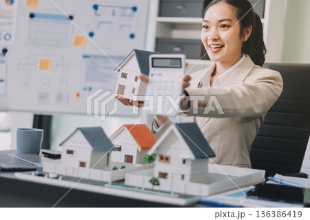 real estate agent home miniature model on documents sale and purchase of apartment notarial deed 136386419