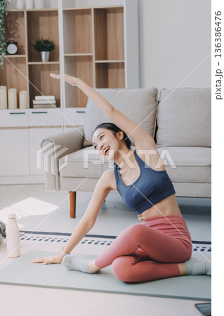 Young Asian sporty attractive people practicing yoga lesson with instructor. Asia group of women exercising healthy lifestyle in fitness studio. Sport activity, gymnastics or ballet dancing class. Young Asian sporty attractive people practicing yoga lesson with instructor. Asia group of women exercising healthy lifestyle in fitness studio. Sport activity, gymnastics or ballet dancing class. 136386476