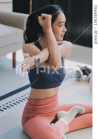 Young Asian sporty attractive people practicing yoga lesson with instructor. Asia group of women exercising healthy lifestyle in fitness studio. Sport activity, gymnastics or ballet dancing class. Young Asian sporty attractive people practicing yoga lesson with instructor. Asia group of women exercising healthy lifestyle in fitness studio. Sport activity, gymnastics or ballet dancing class. 136386482