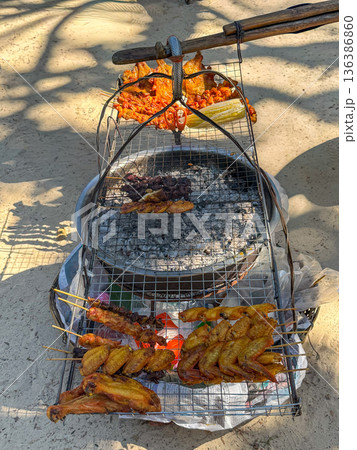 Thai street food barbecue chicken grilling on beach 136386860