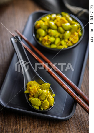 Fresh salad with edamame beans on ceramic spoon on wooden table. Fresh salad with edamame beans on ceramic spoon on wooden table. 136387175