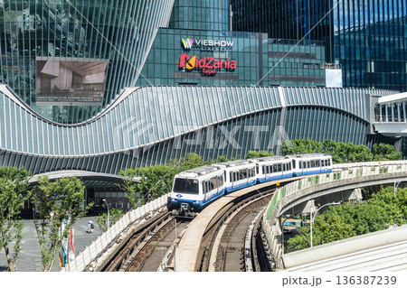 A train on the Wenhu or Brown Line of the Taipei MRT passes by the Mitsui Shopping Park LaLaport Taipei Nangang. 136387239