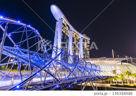 Night view of The Helix Bridge and the Marina Bay Sands Resort, Singapore, it's a pedestrian bridge linking the Marina Centre with Marina South. Night view of The Helix Bridge and the Marina Bay Sands Resort, Singapore, it's a pedestrian bridge linking the Marina Centre with Marina South. 136388086