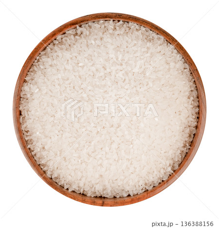 Rice cereal in a brown wooden bowl isolated on white background 136388156