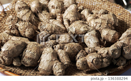 Dried ginger on a wooden plate. 136388294