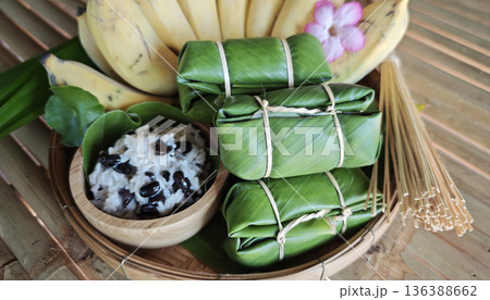 Khao Tom Mud before cooking,Traditional Thai dessert sticky rice, coconut milk and banana wrapped and black beans in banana leaves Khao Tom Mud before cooking,Traditional Thai dessert sticky rice, coconut milk and banana wrapped and black beans in banana leaves 136388662