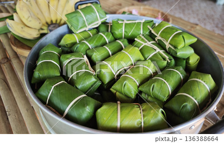 Khao Tom Mud before cooking,Traditional Thai dessert sticky rice, coconut milk and banana wrapped and black beans in banana leaves 136388664