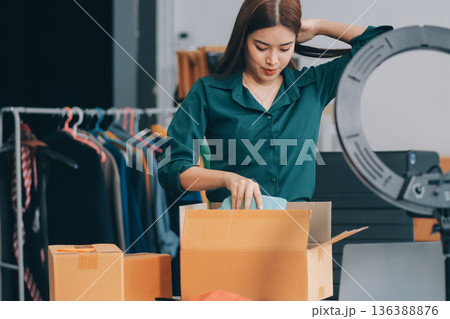 Starting small businesses SME owners female entrepreneurs check online orders to prepare to pack the boxes, sell to customers, sme business ideas online. 136388876