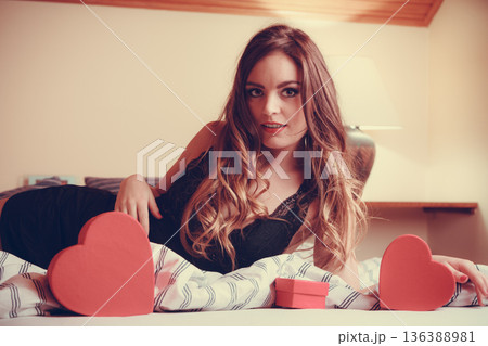 Woman in lingerie in bed. Valentines day love. Woman in lingerie in bed. Valentines day love. 136388981