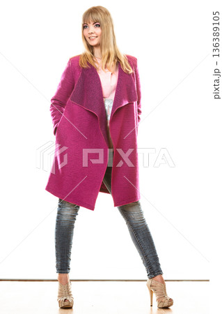 blonde fashionable woman in vivid color coat. blonde fashionable woman in vivid color coat. 136389105