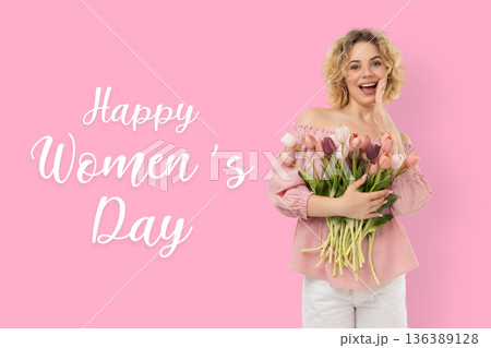A woman holds flowers while celebrating Women's Day A woman holds flowers while celebrating Women's Day 136389128
