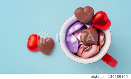 Heart shaped chocolate in red cup on blue background, Valentines day, love concept, top view Heart shaped chocolate in red cup on blue background, Valentines day, love concept, top view 136389169
