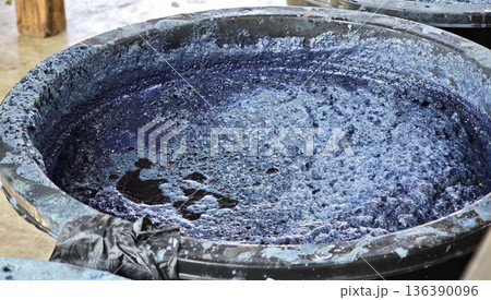 Indigo liquid in an indigo curing tank Ready for dyeing Indigo liquid in an indigo curing tank Ready for dyeing 136390096