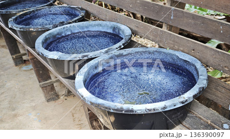 Indigo liquid in an indigo curing tank Ready for dyeing Indigo liquid in an indigo curing tank Ready for dyeing 136390097