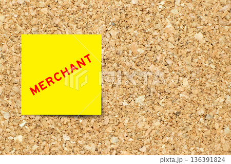 Yellow note paper with word merchant on cork board background with copy space Yellow note paper with word merchant on cork board background with copy space 136391824