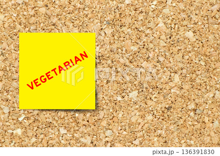 Yellow note paper with word vegetarian on cork board background with copy space Yellow note paper with word vegetarian on cork board background with copy space 136391830