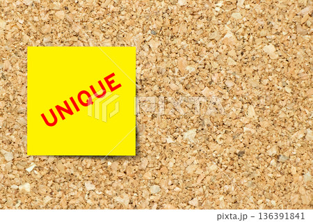 Yellow note paper with word unique on cork board background with copy space Yellow note paper with word unique on cork board background with copy space 136391841