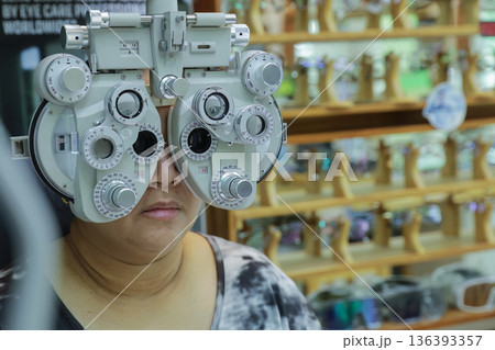 Phoropter for eye test, lenses glasses for eye check in optical store. Phoropter for eye test, lenses glasses for eye check in optical store. 136393357