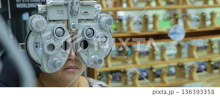 Phoropter for eye test, lenses glasses for eye check in optical store. Phoropter for eye test, lenses glasses for eye check in optical store. 136393358
