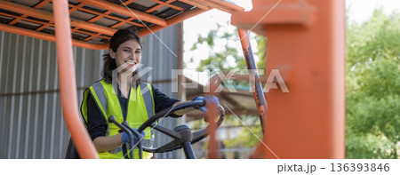 Woman worker at forklift driver happy working in industry factory logistic ship. Woman worker at forklift driver happy working in industry factory logistic ship. 136393846