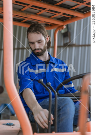 Man worker at forklift driver happy working in industry factory logistic ship.  136393994